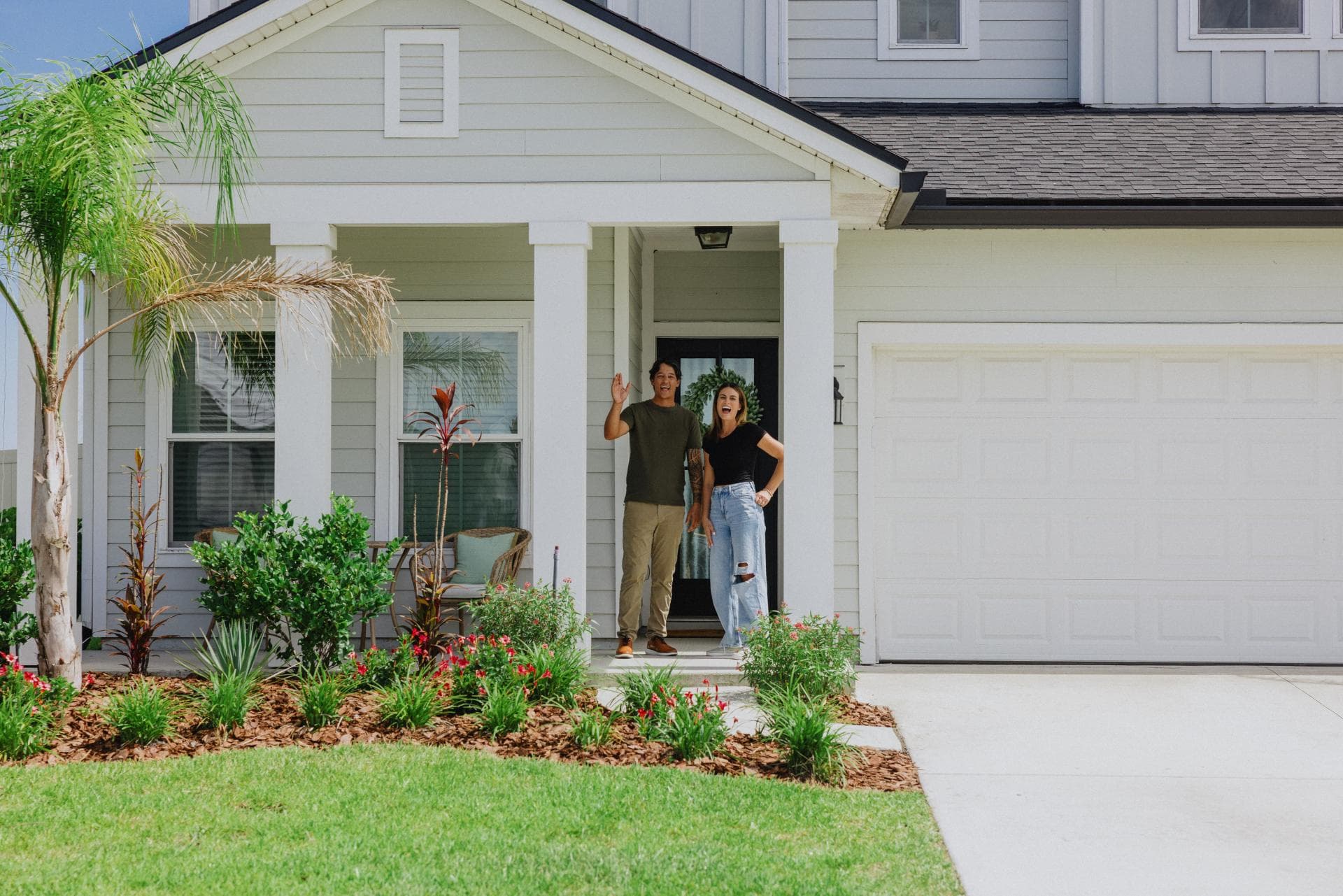 Family of non-qm mortgage stands in front of home